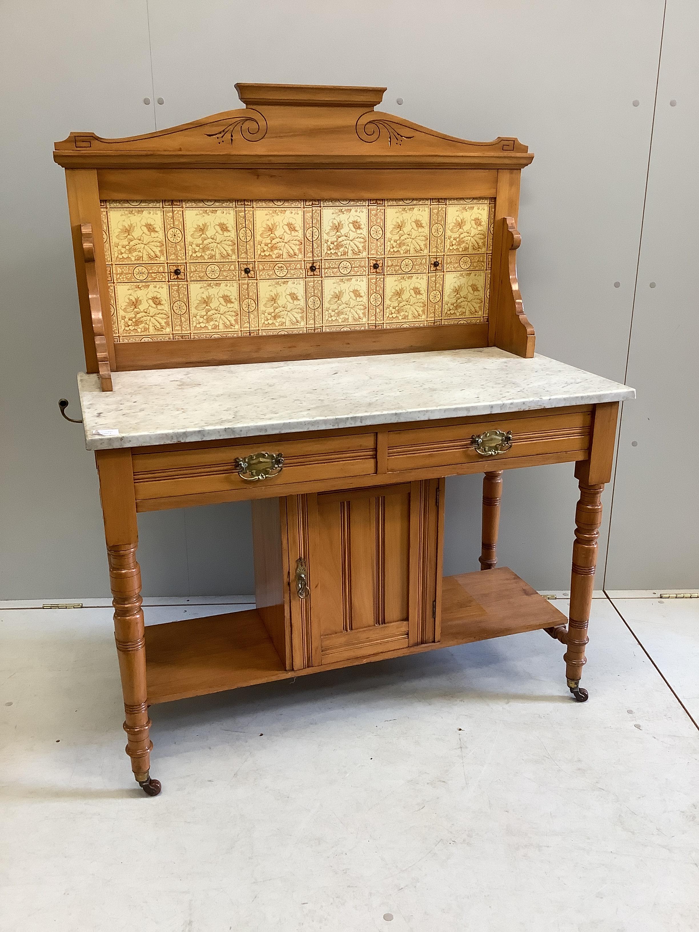 A late Victorian satin walnut tiled back marble top washstand, width 106cm, depth 52cm, height 133cm